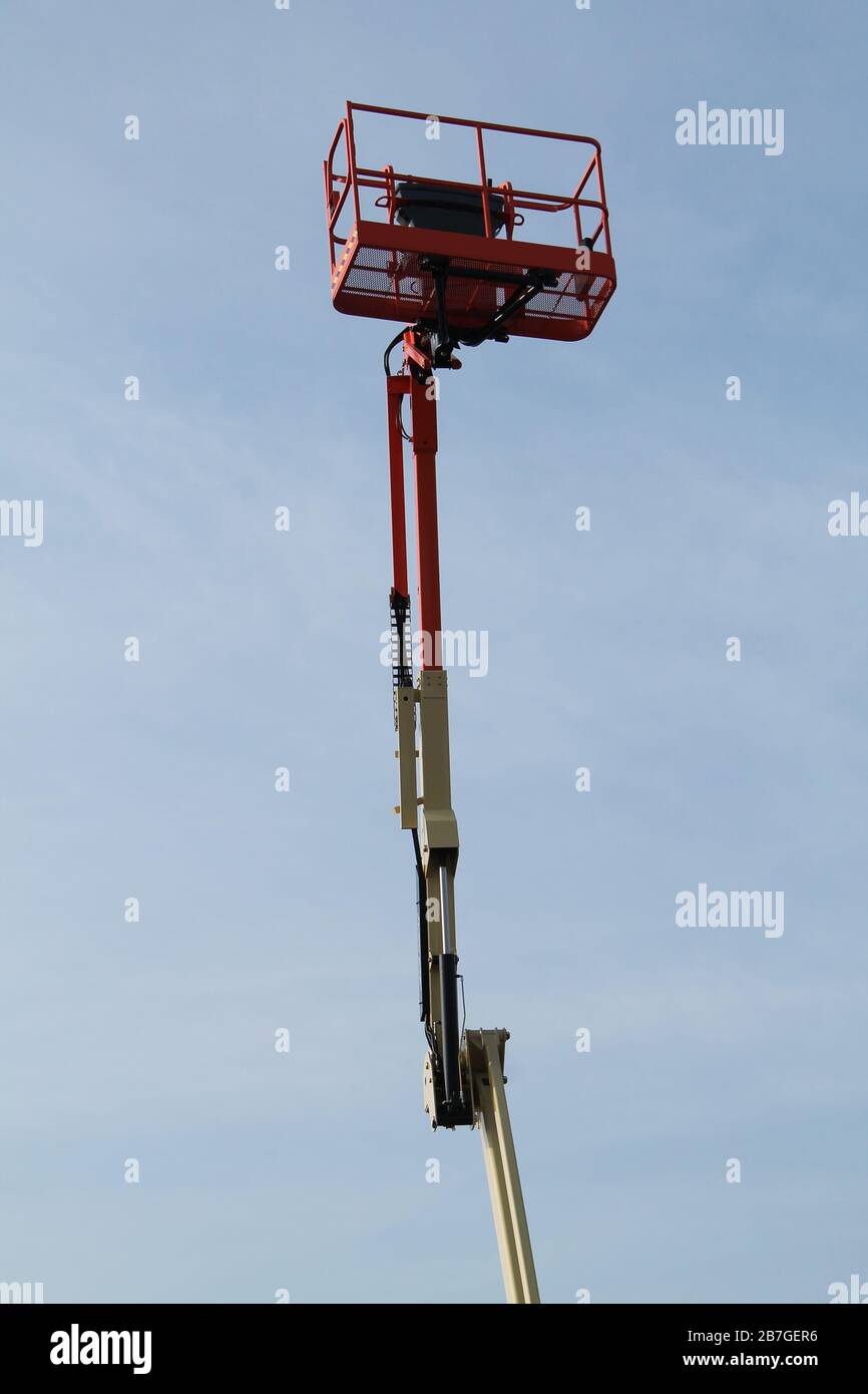 A Very High Extended Arm and Cage of a Cherry Picker. Stock Photo
