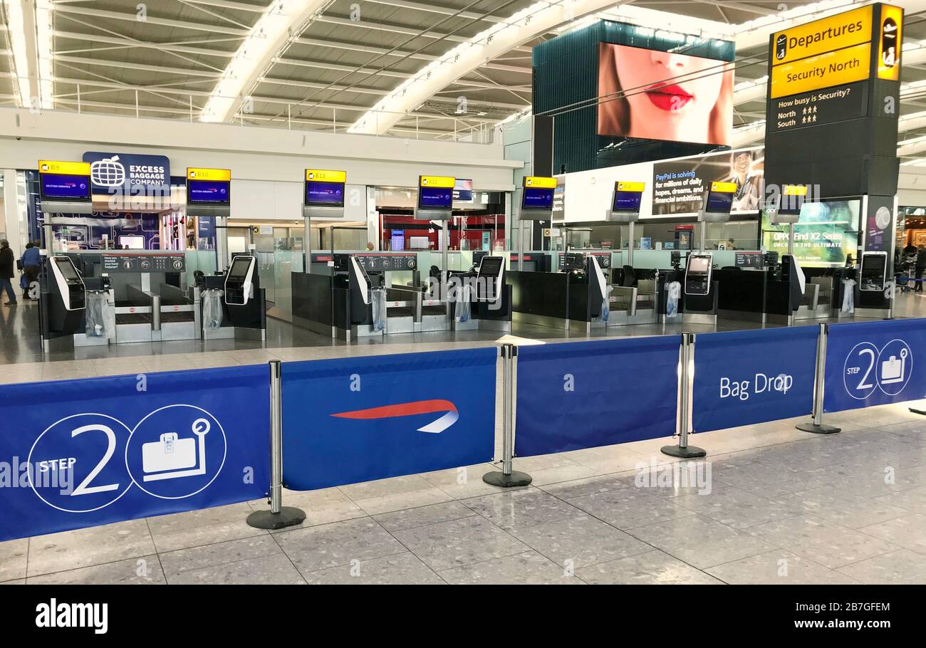 Deserted check-in desks at Terminal Five of London's Heathrow Airport after flight schedules were slashed by British Airways' parent company IAG. Stock Photo