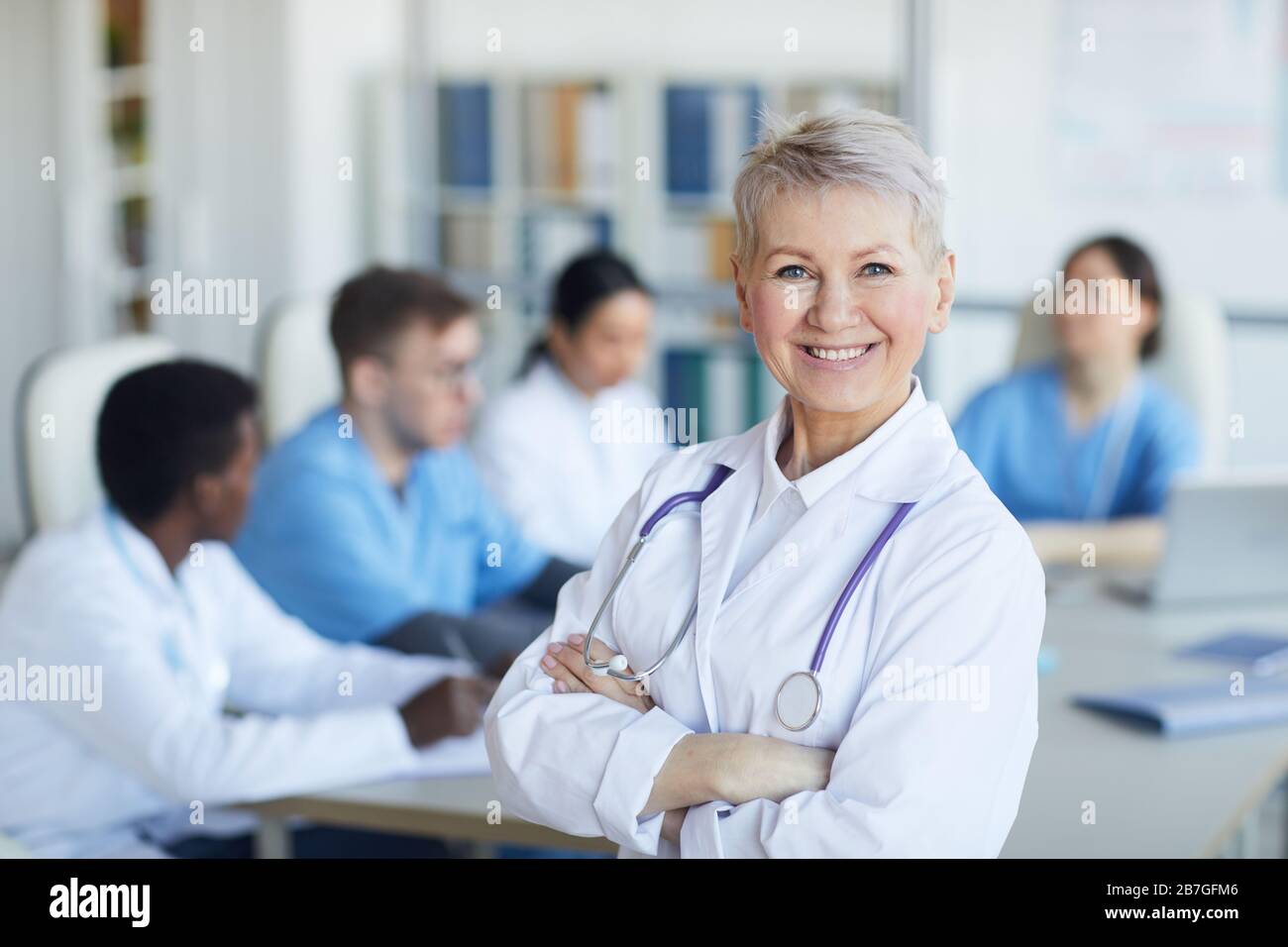 Senior female doctor arms crossed hi-res stock photography and images ...