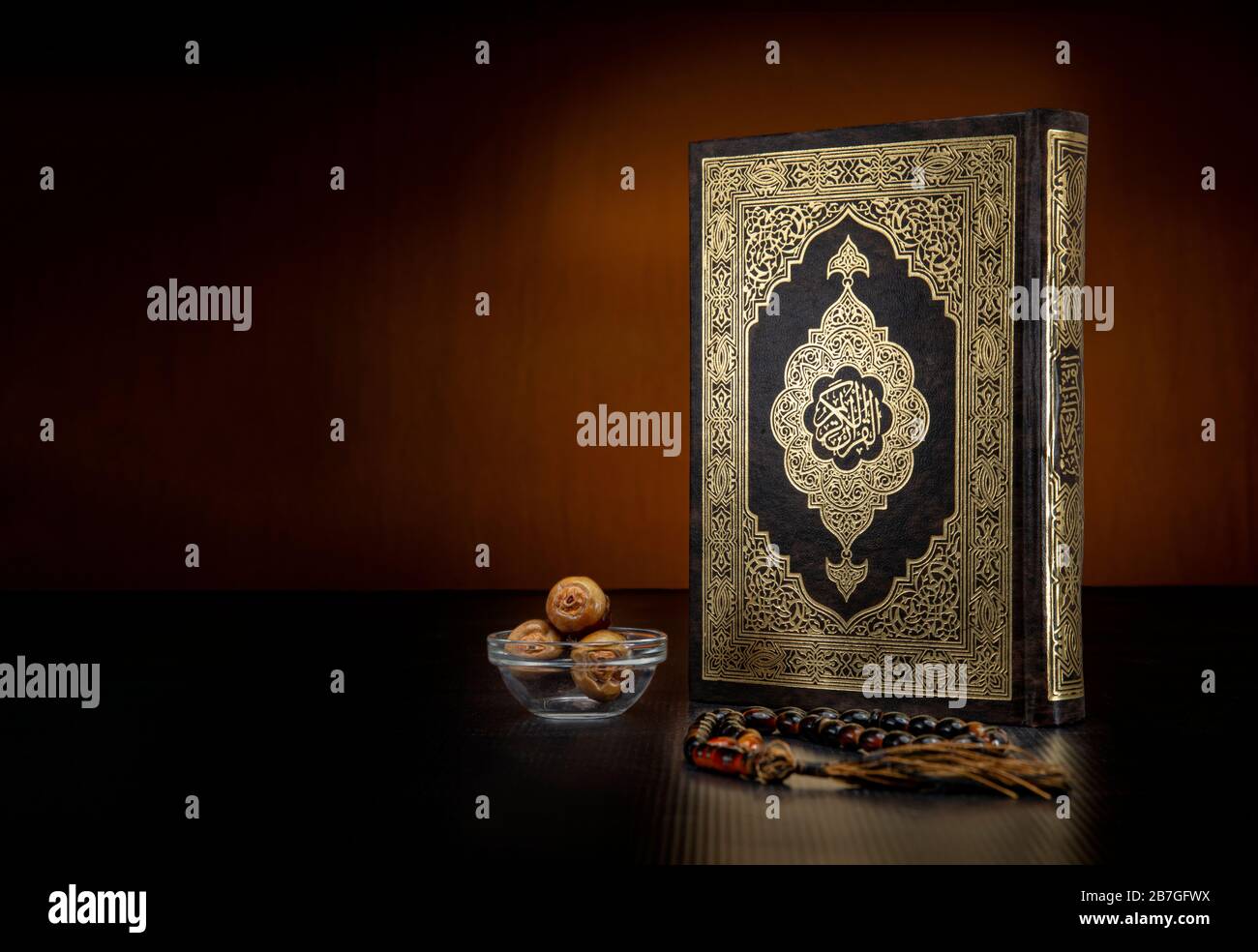 Holy Book of Quran With Rosary and Dates on Black Background, Celebrating Holy Month of Ramadan Stock Photo