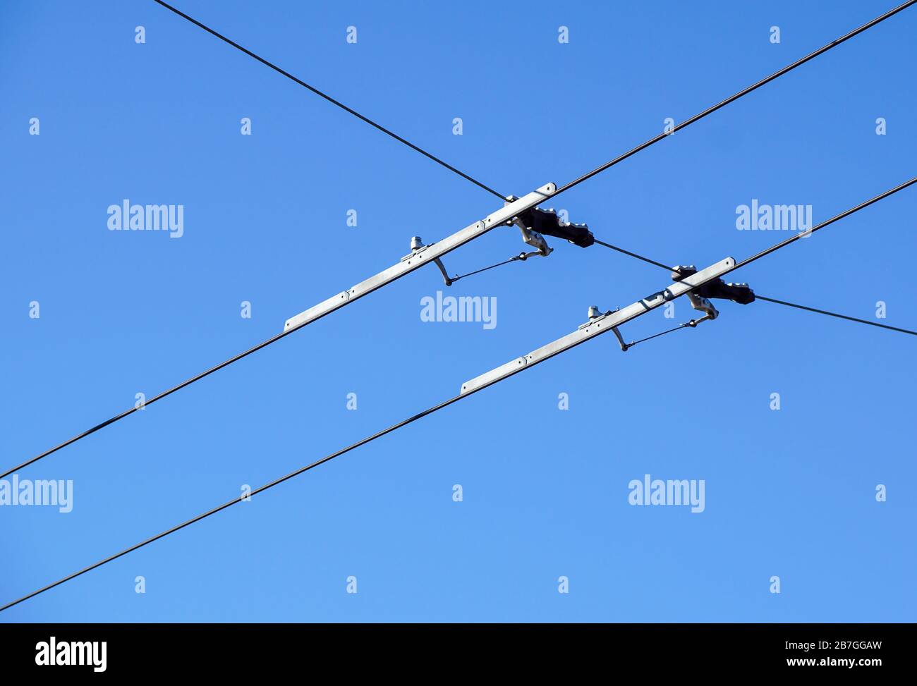 Electric streetcar wires overhead Trolley, Trams. Blue sky Stock Photo