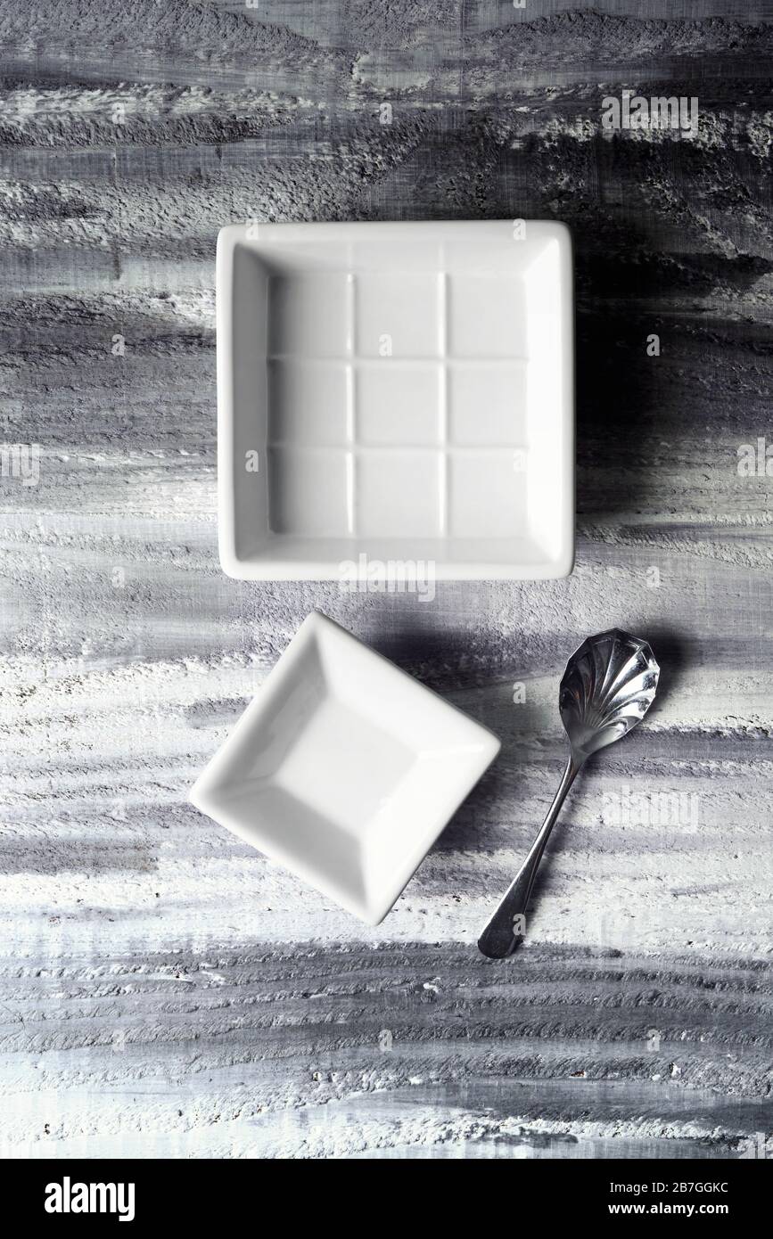 White dishes on mono rustic background Stock Photo