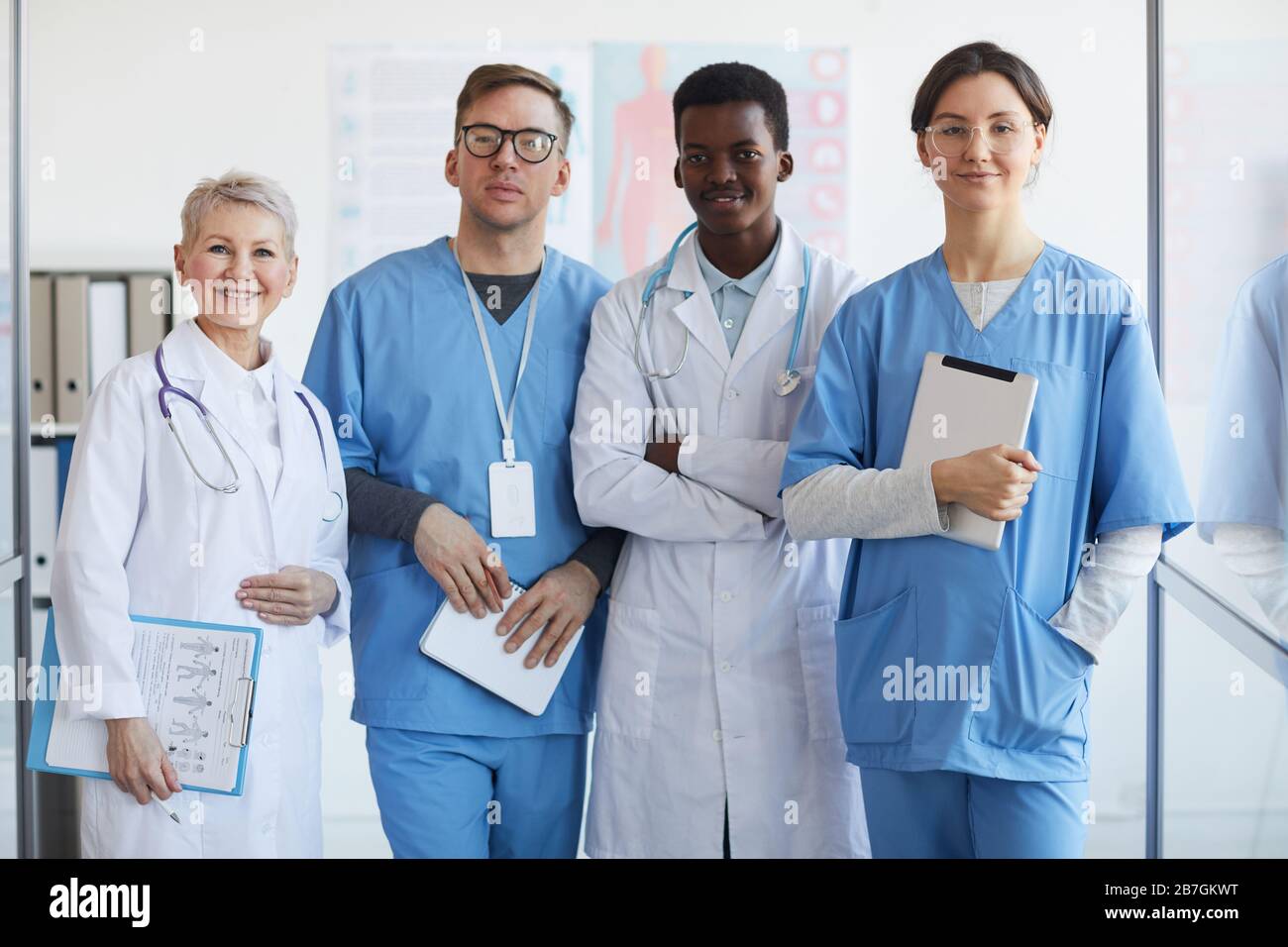 Multi-ethnic group of doctors looking at camera while posing together ...