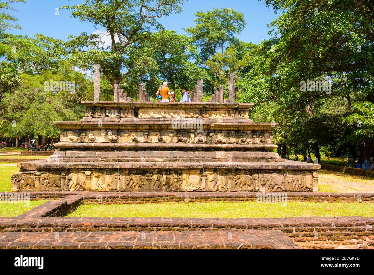 Asia Sri Lanka Polonnaruwa Royal Court of King Parakramabahu 3 layers pillars columns tourists trees blue sky Stock Photo
