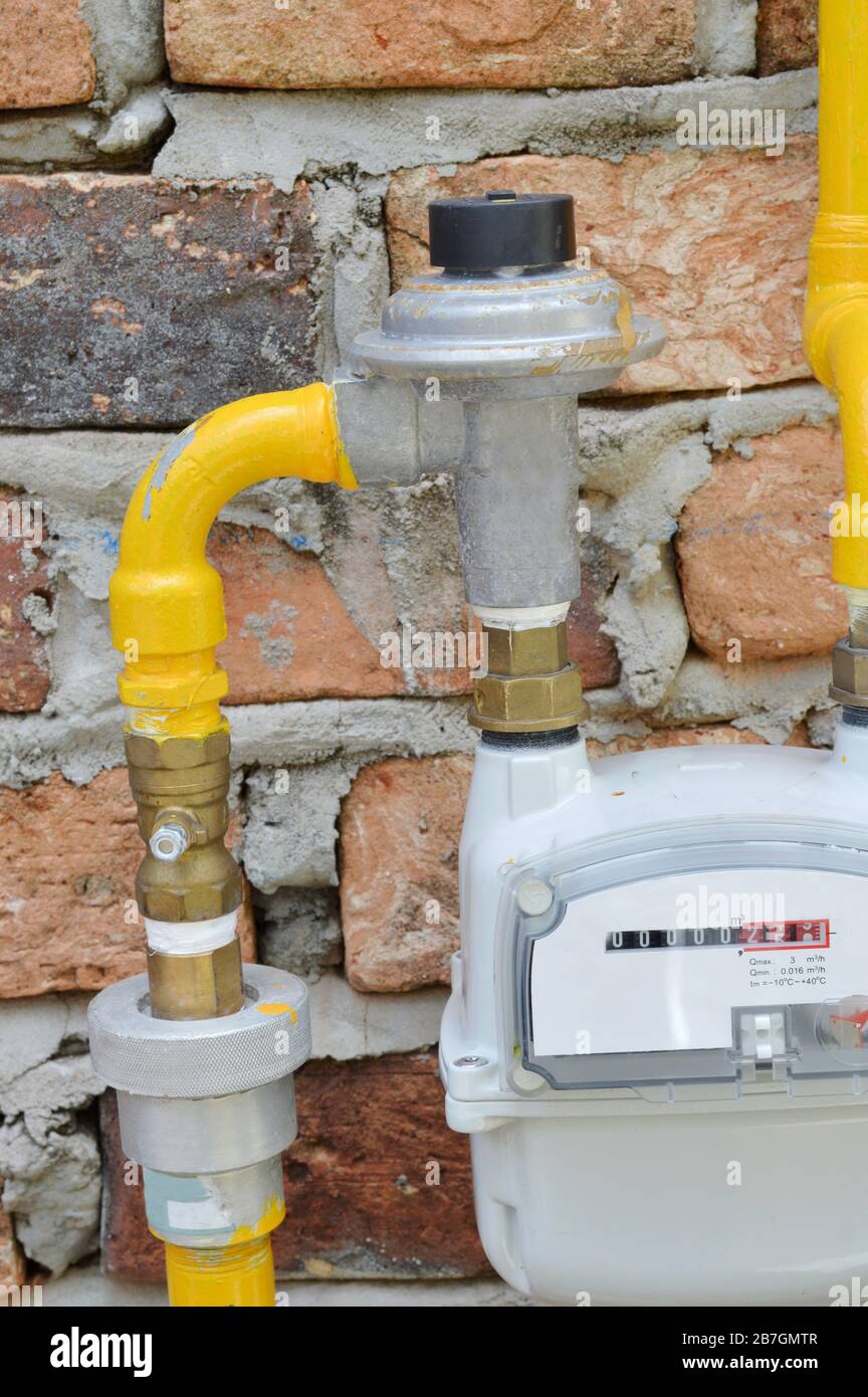yellow gas pipe meter on the wall Stock Photo Alamy