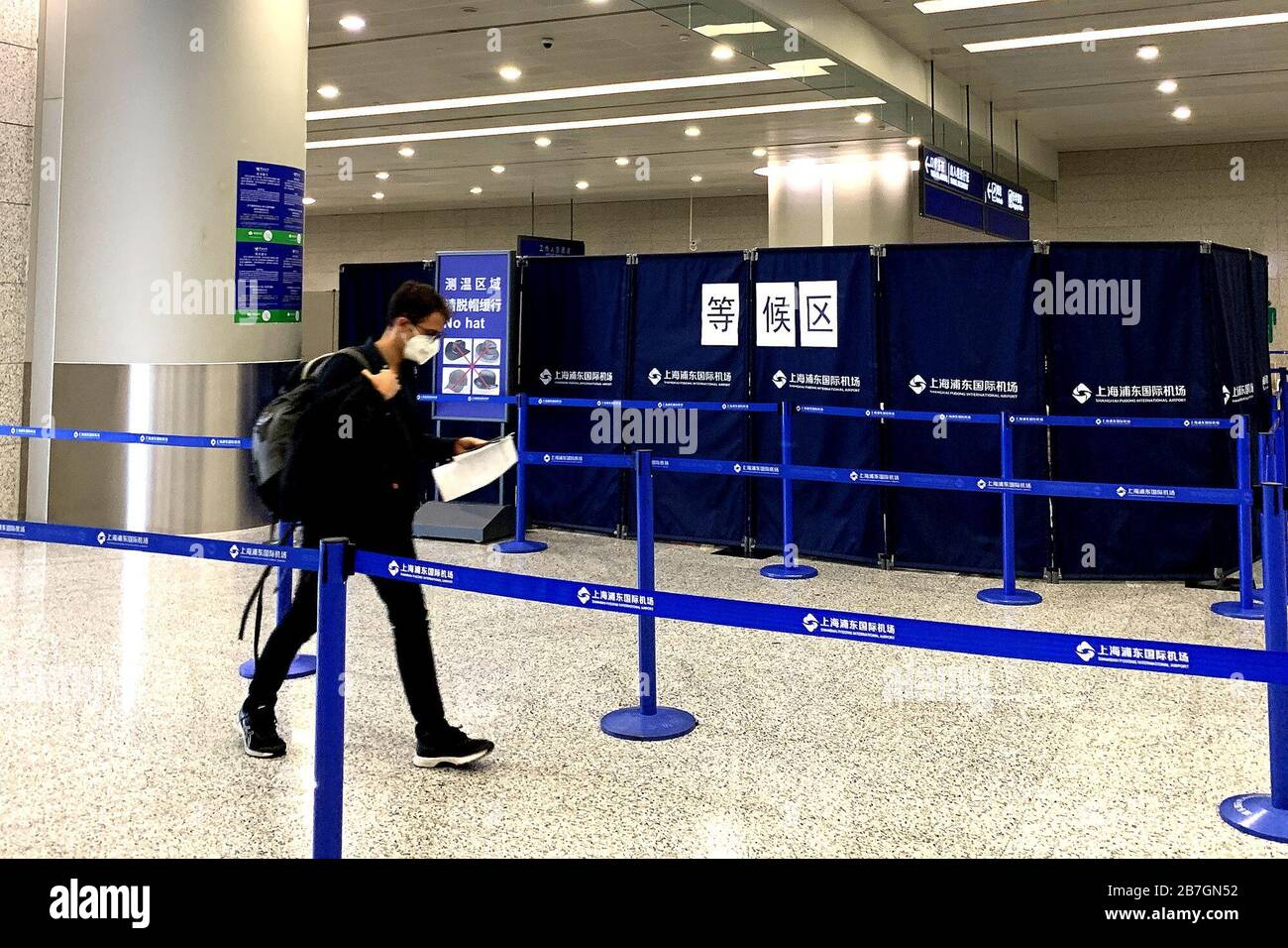 Beijing, March 15. 16th Mar, 2020. A passenger walks into the waiting area for temperature check and information registration at the Shanghai Pudong International Airport in Shanghai, east China, March 15, 2020. TO GO WITH XINHUA HEADLINES OF MARCH 16, 2020. Credit: Yuan Quan/Xinhua/Alamy Live News Stock Photo