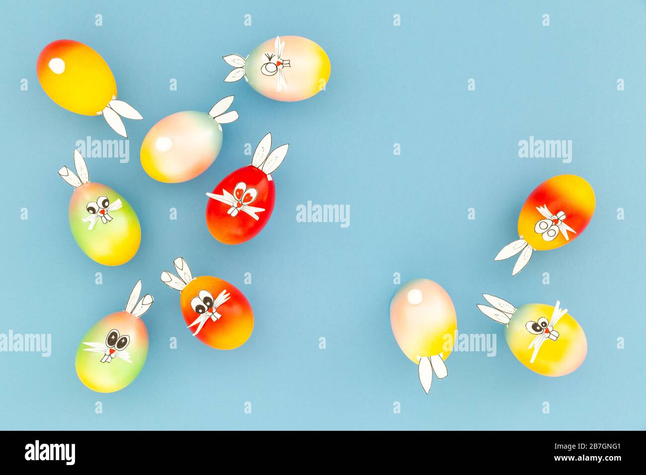 Colorful painted easter eggs with funny bunny ears and cartoon faces on ...
