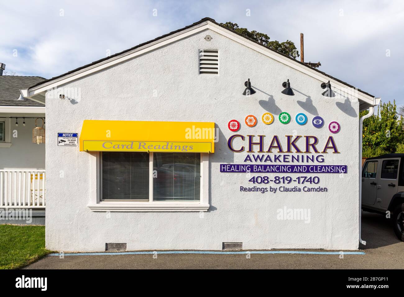 'Card Readings', 'Chakra Awakening', 'Healing Balancing & Cleansing', signs on house, San José, California, USA Stock Photo