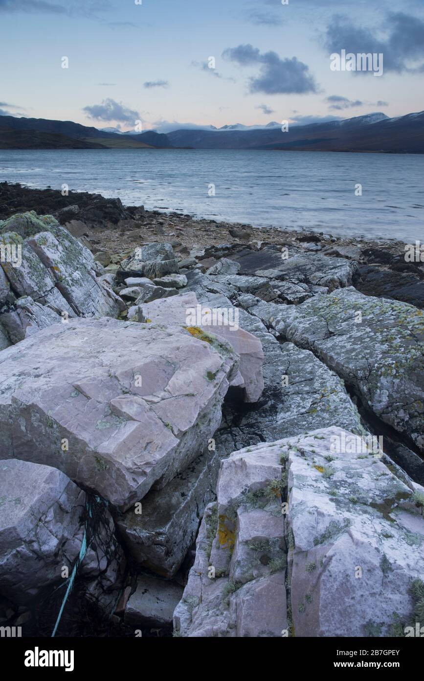 Limestone boulders and wave cut rocks on the shores of Loch Eriboll, Sutherland, Scotland, UK Stock Photo