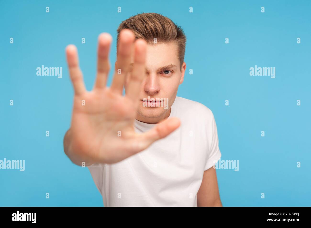 Ban, prohibition concept. Portrait of serious man in white tshirt