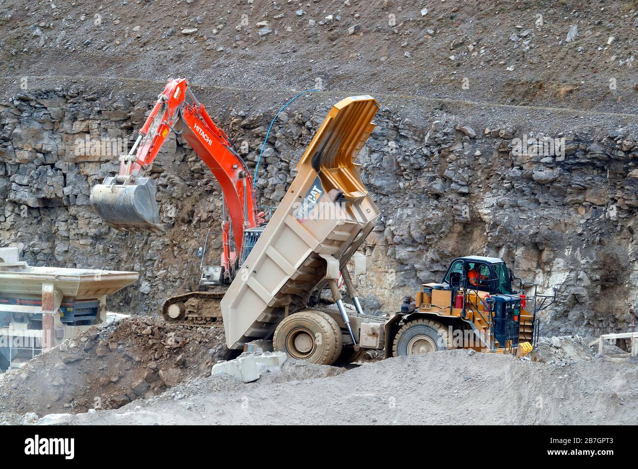 A Caterpillar 775G truck and a Hitachi 360 excavator working in Coldstones Quarry, Greenhow Hill, Niddedale in North Yorkshire. Stock Photo