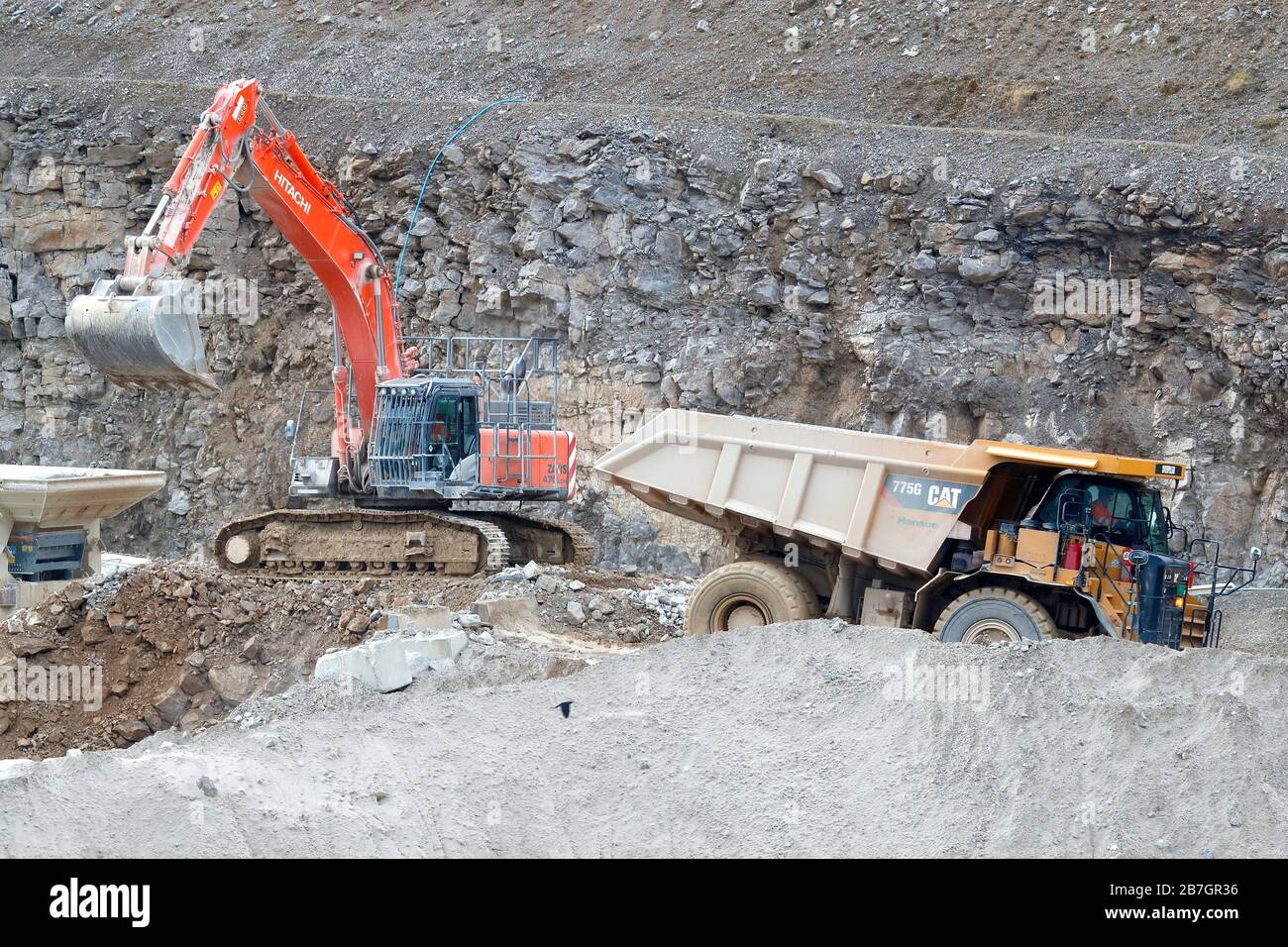 A Caterpillar 775G truck and a Hitachi 360 excavator working in Coldstones Quarry, Greenhow Hill, Niddedale in North Yorkshire. Stock Photo