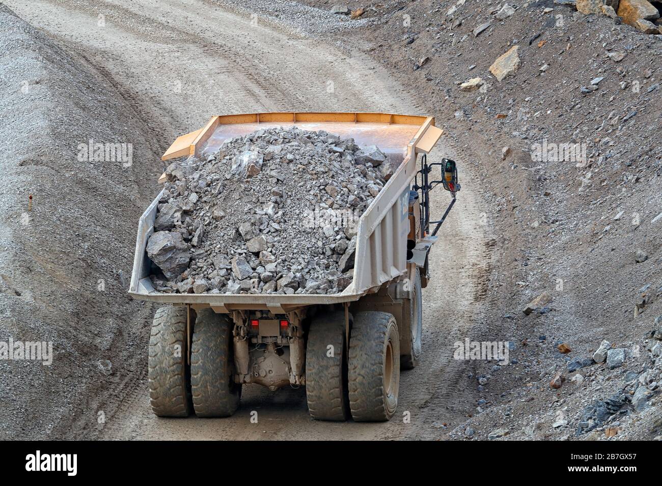 A Caterpillar 775G truck carring a full load at Coldstones Quarry, Greenhow Hill, Niddedale in North Yorkshire. Stock Photo