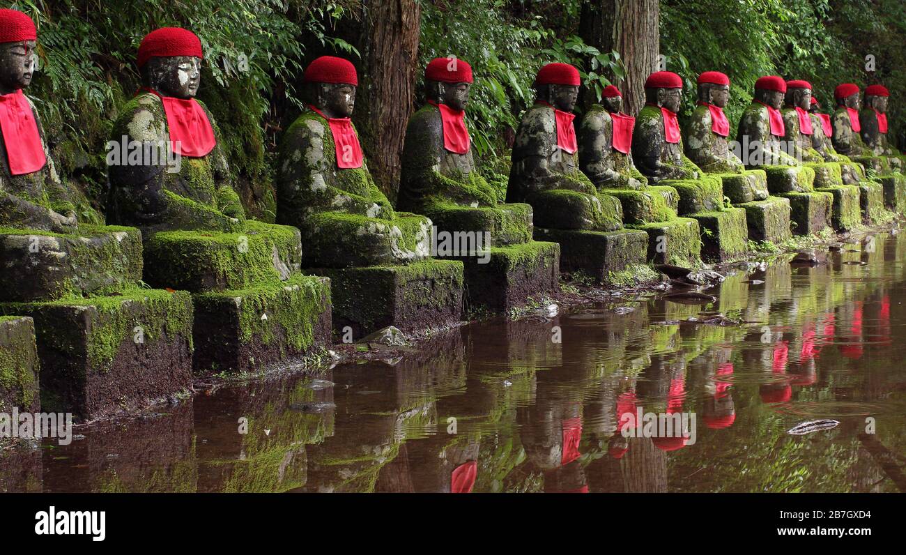 Aligned jizo buddhist statues in Nikko, Japan (Kanmangafuchi Abyss) Stock Photo
