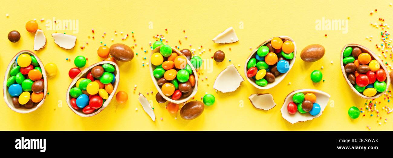 Download Chocolate Easter Eggs And Colorful Candies On Yellow Paper Background Flat Lay Top View Overhead Template Mockup Stock Photo Alamy