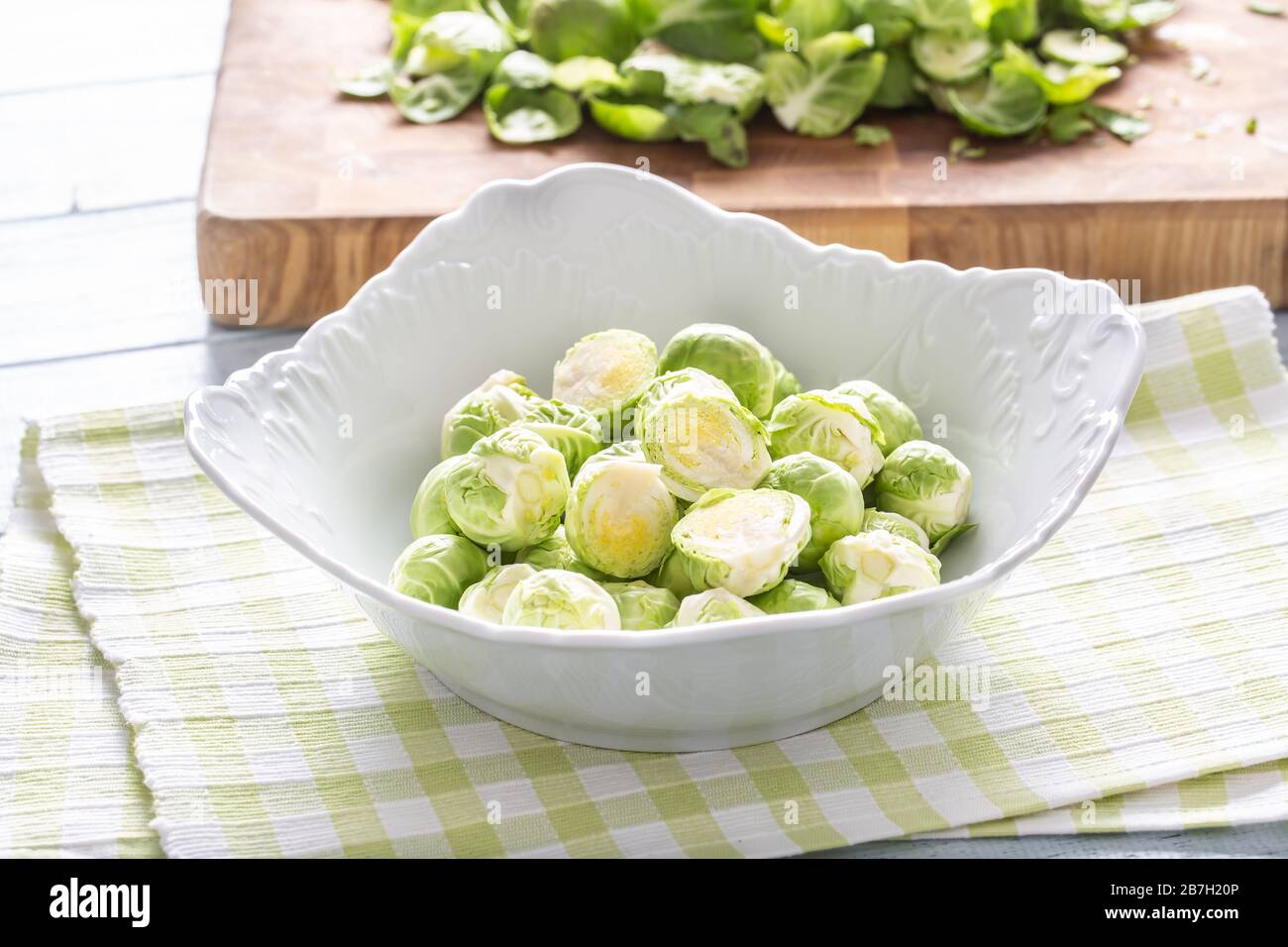 Fresh brusseles sprouts in bowl on kitchen table Stock Photo