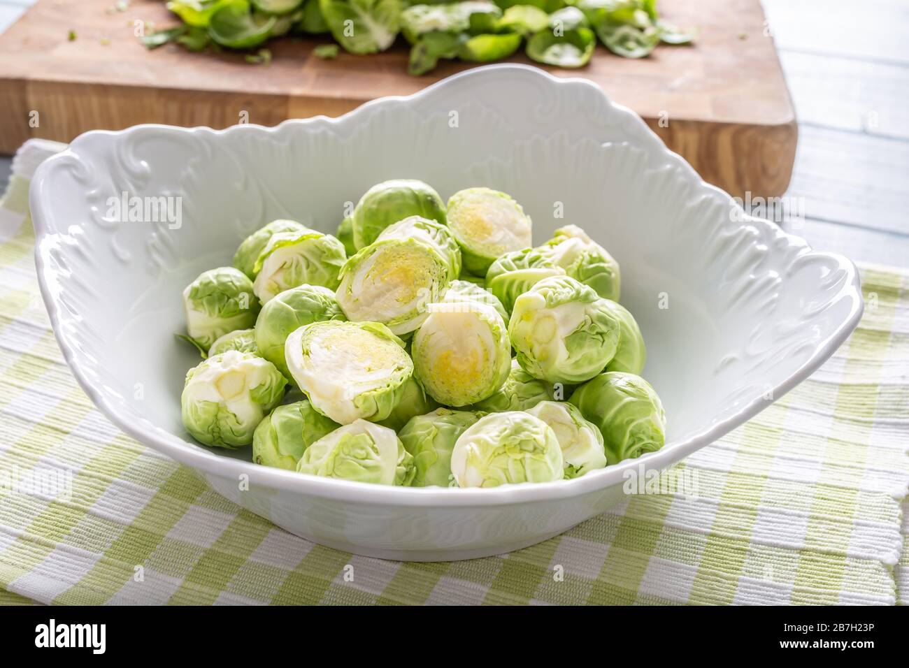 Fresh brusseles sprouts in bowl on kitchen table Stock Photo