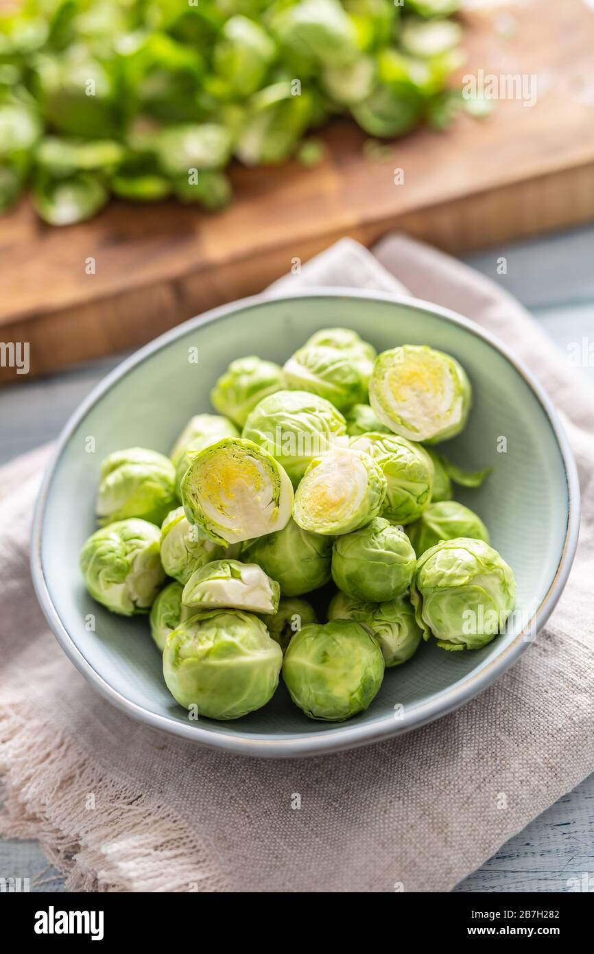Fresh brusseles sprouts in bowl on kitchen table Stock Photo