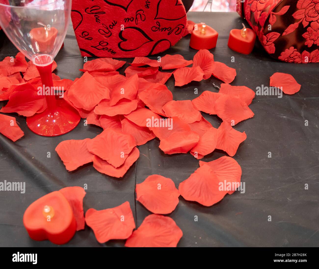 Close up imitation or artificial red roses leaves background Stock