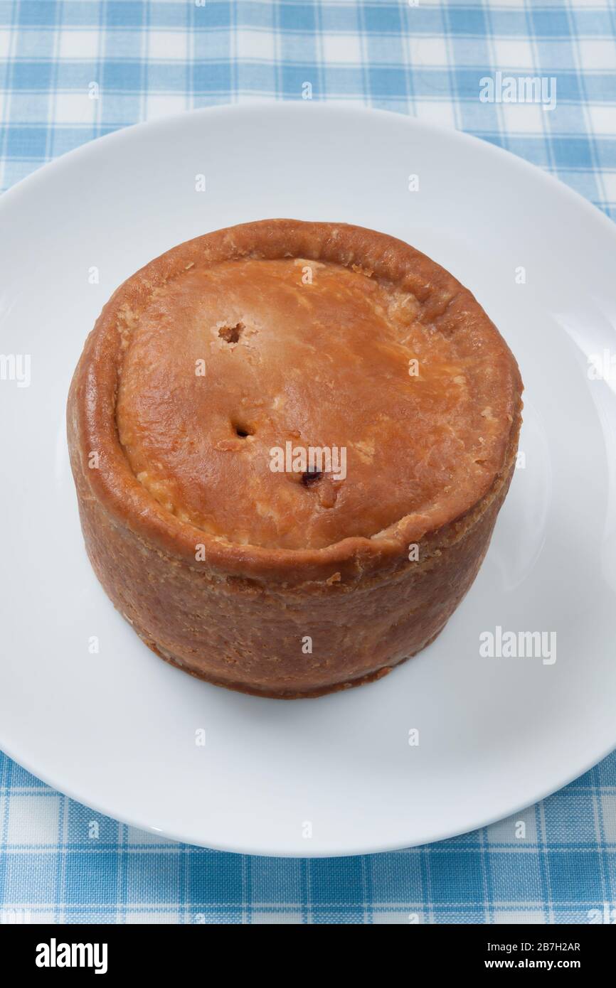 Traditional style British pork pie made with chopped pork jellied pork stock and a hot water crust pastry Stock Photo