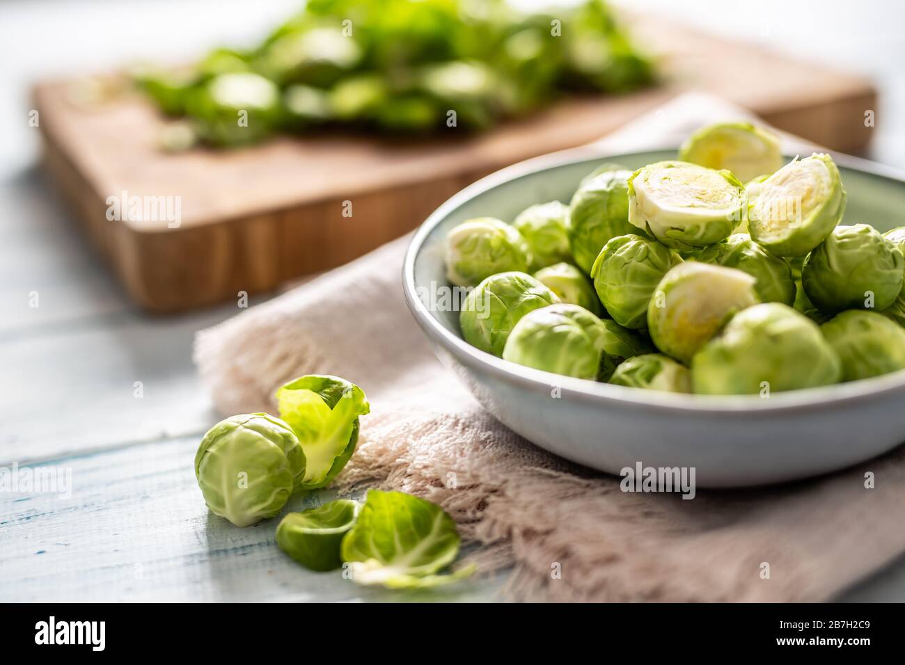 Fresh brusseles sprouts in bowl on kitchen table Stock Photo
