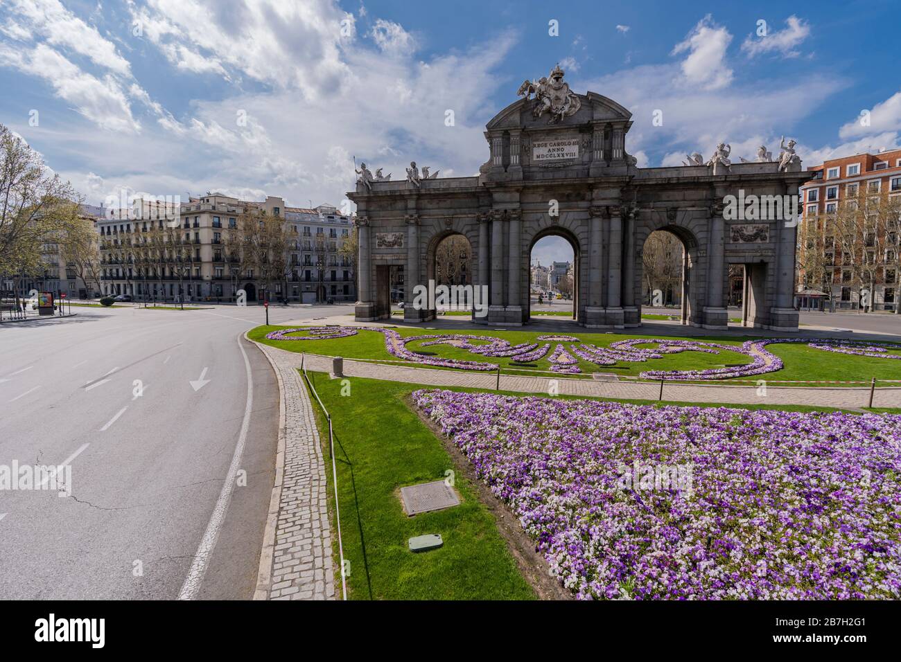 The surroundings of Puerta de Alcalá, one of Madrid's landmarks, appear empty and with no traffic following coronavirus lockdown Stock Photo