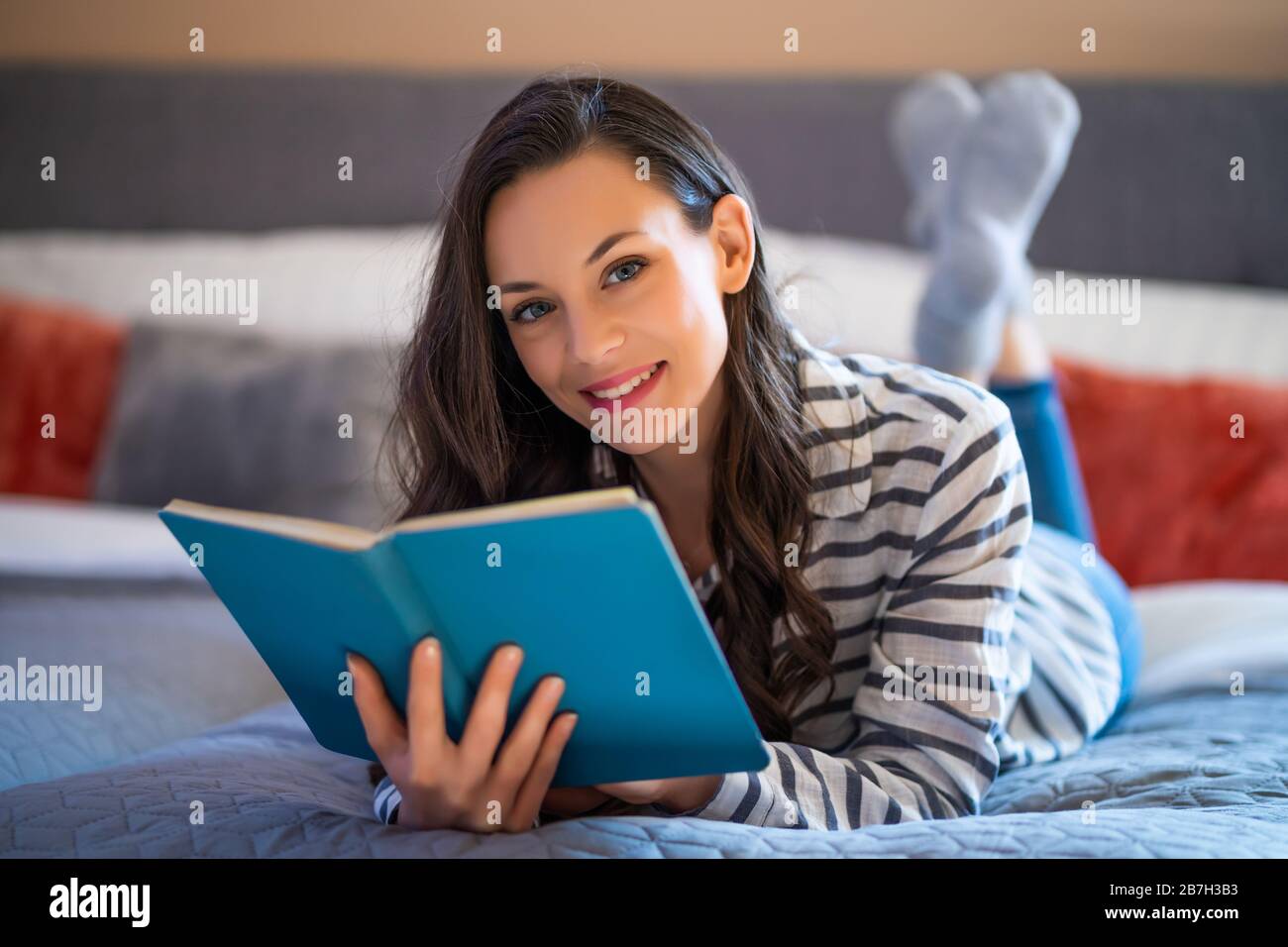 Woman lying on bed in hi-res stock photography and images - Alamy