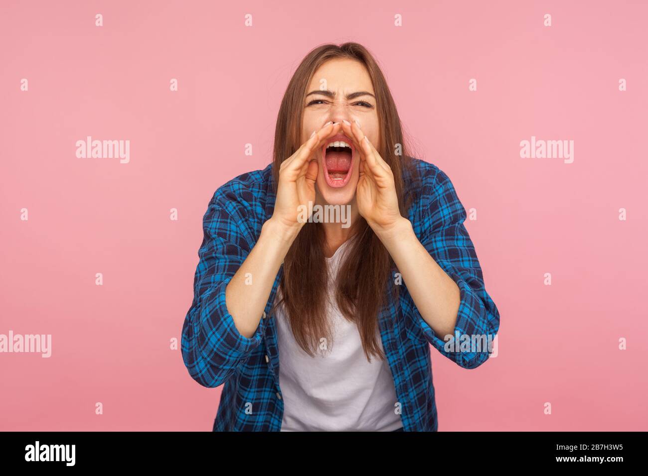 Attention, advertisement! Portrait of girl in checkered shirt holding ...