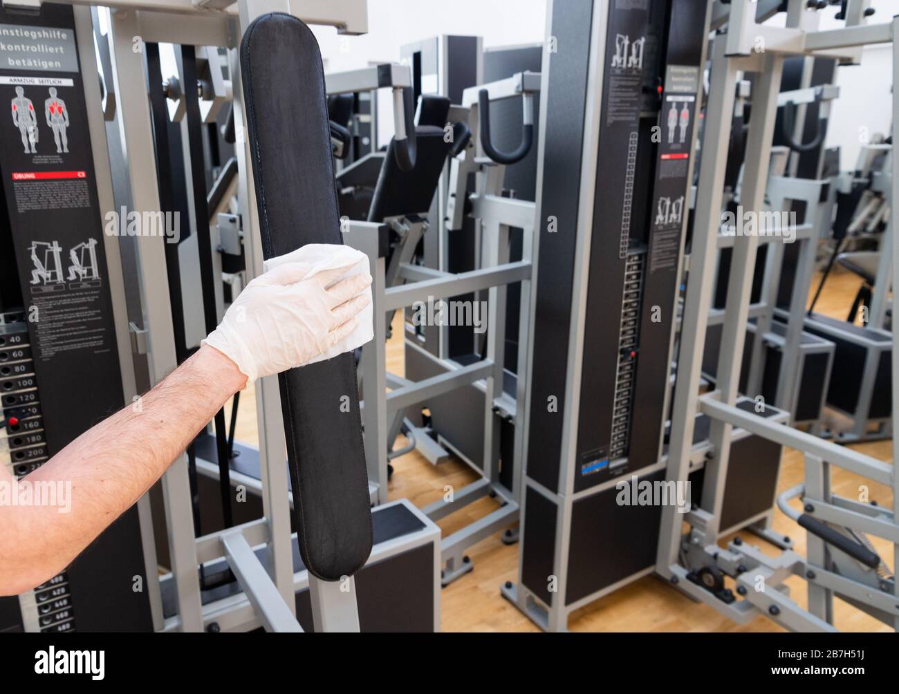 Dresden, Germany. 16th Mar, 2020. An employee of a fitness studio disinfects the sports equipment. The effects of the coronavirus epidemic are also noticeable here Credit: Robert Michael/dpa-Zentralbild/dpa/Alamy Live News Stock Photo