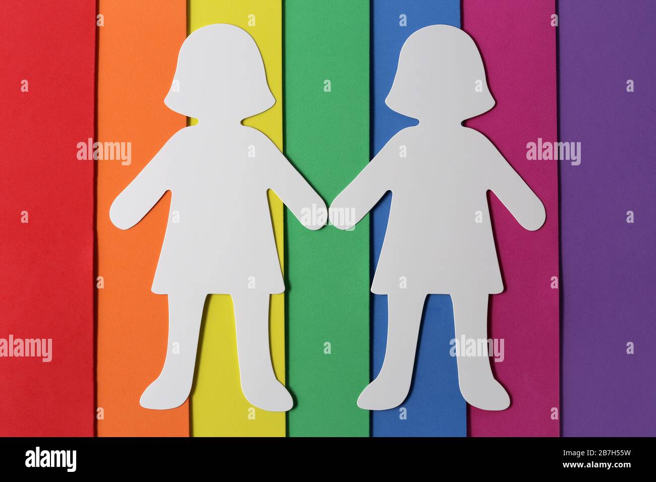 LGBT culture symbol, homosexual family concept,silhouette of women on colored flag Stock Photo