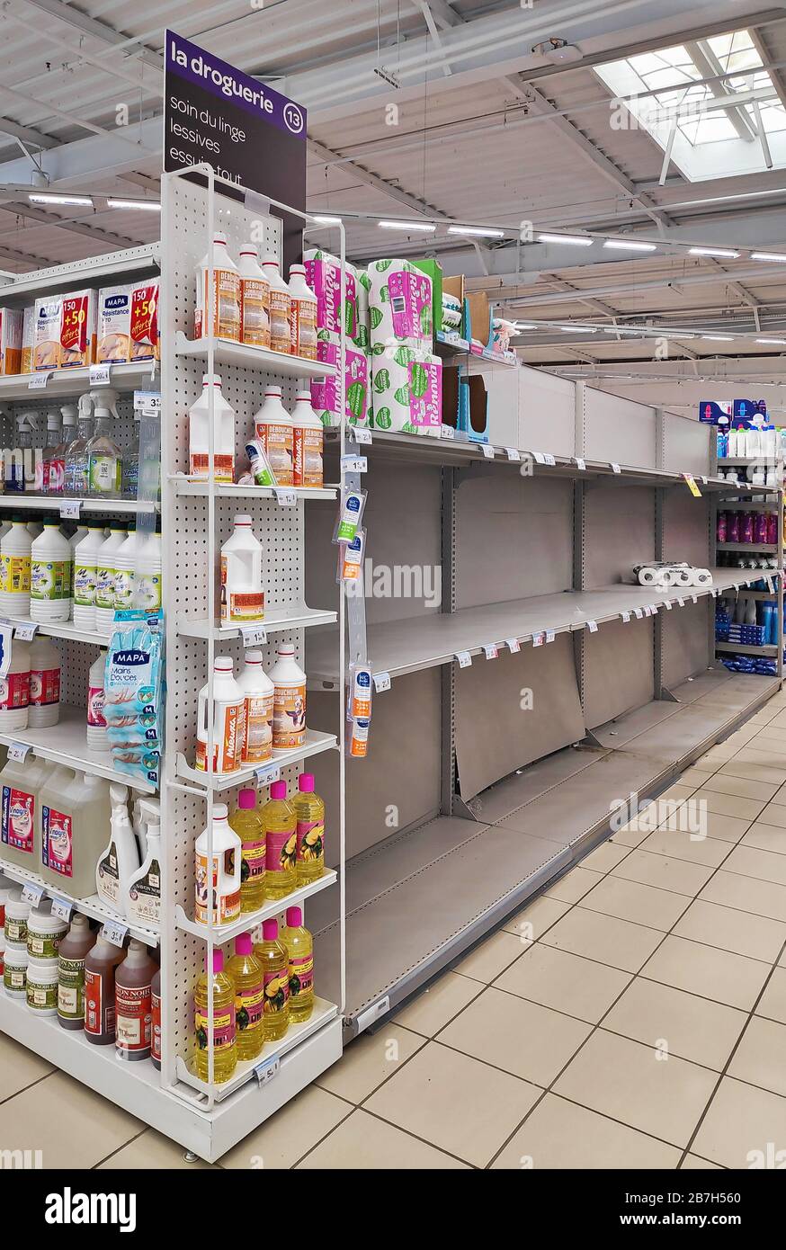 Paris, France - March 15 2020: Shelves of a supermarket normally filled with rolls of toilet paper completely because of Covid-19 pandemic. Stock Photo