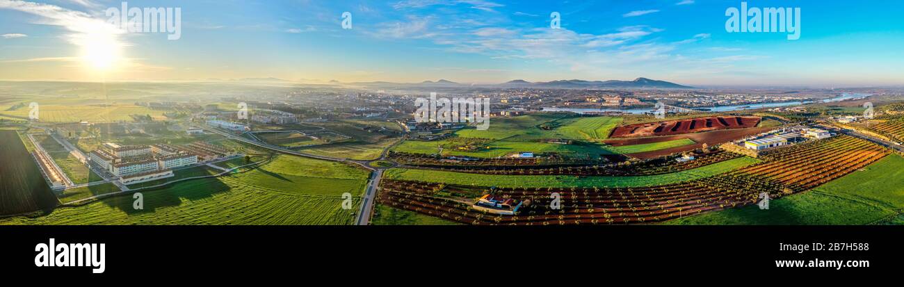 Aerial panoramic view of modern Merida cityscape on banks of Guadiana River. Spain Stock Photo