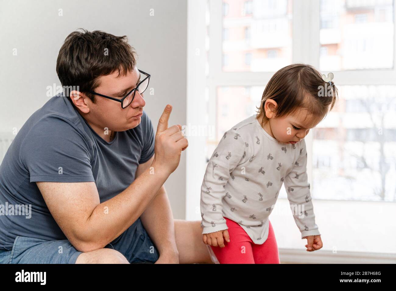 Father punishing his daughter for her bad behaviour. Strict parenting concept Stock Photo