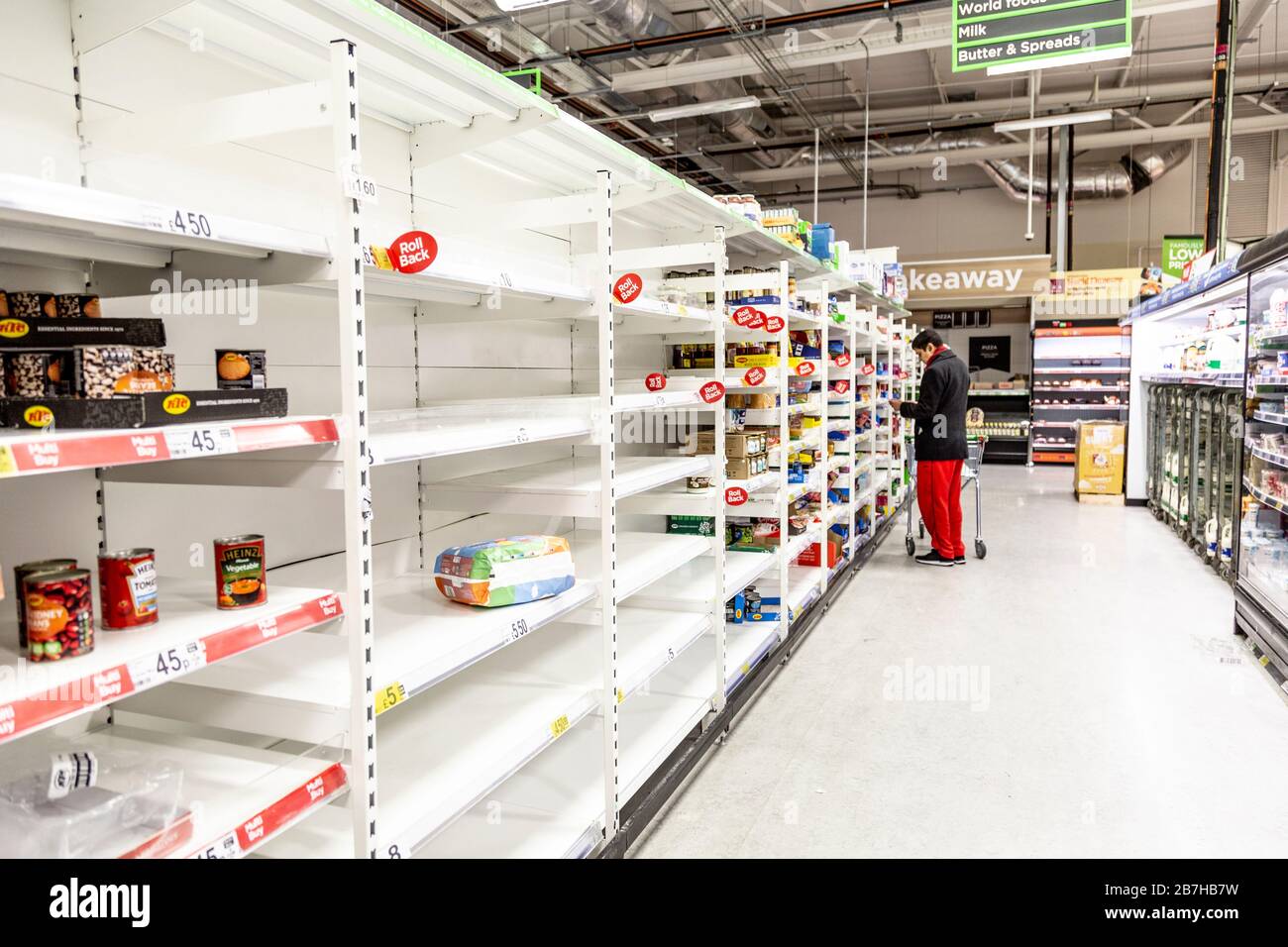 16 March 2020 - London, UK - Empty supermarket shelves at ASDA Stepney as people panic buy to stock up during the Coronavirus outbreak, empty long shelf life isle, out-of-stock canned and jarred products, grains, pasta and rice Stock Photo