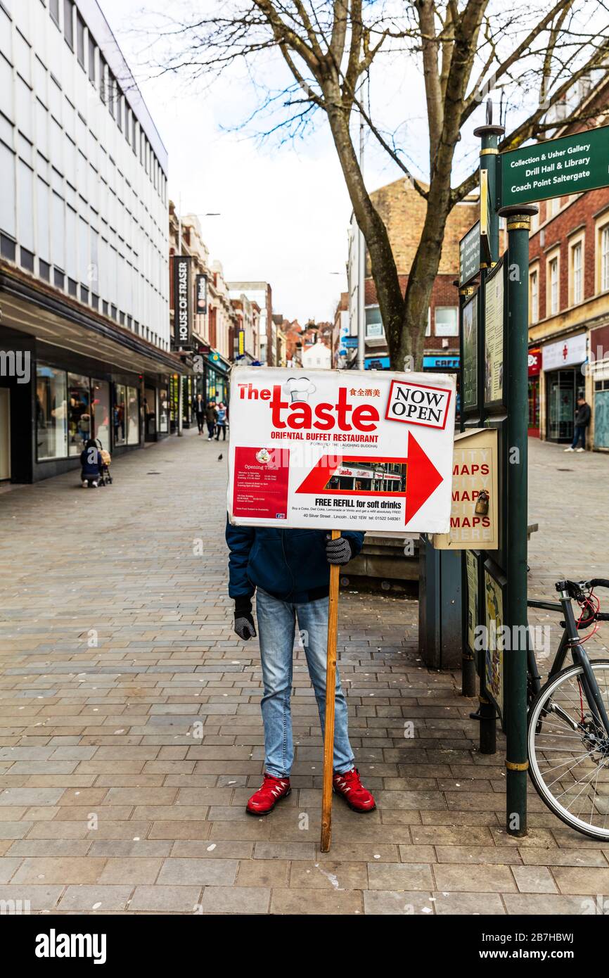 Lincoln City Lincolnshire UK England, holding advertising board