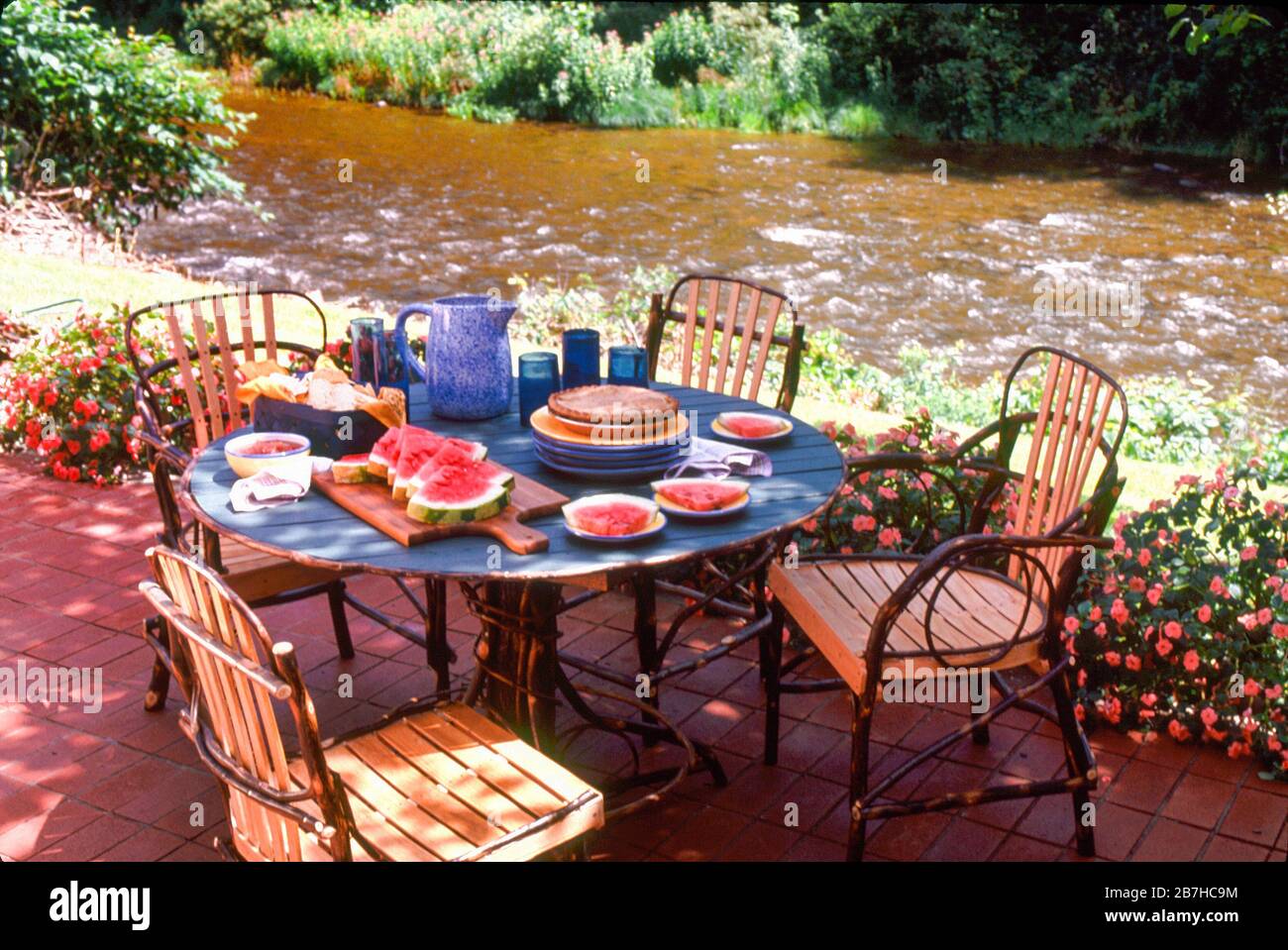 Waterfront picnic setting, rustic table and chairs Stock Photo Alamy
