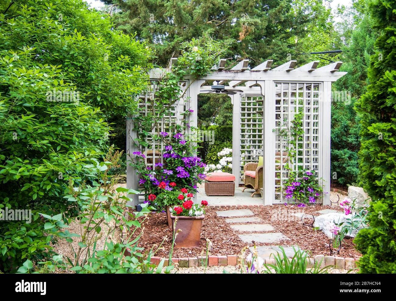 Pergola, outdoor room in flower garden Stock Photo