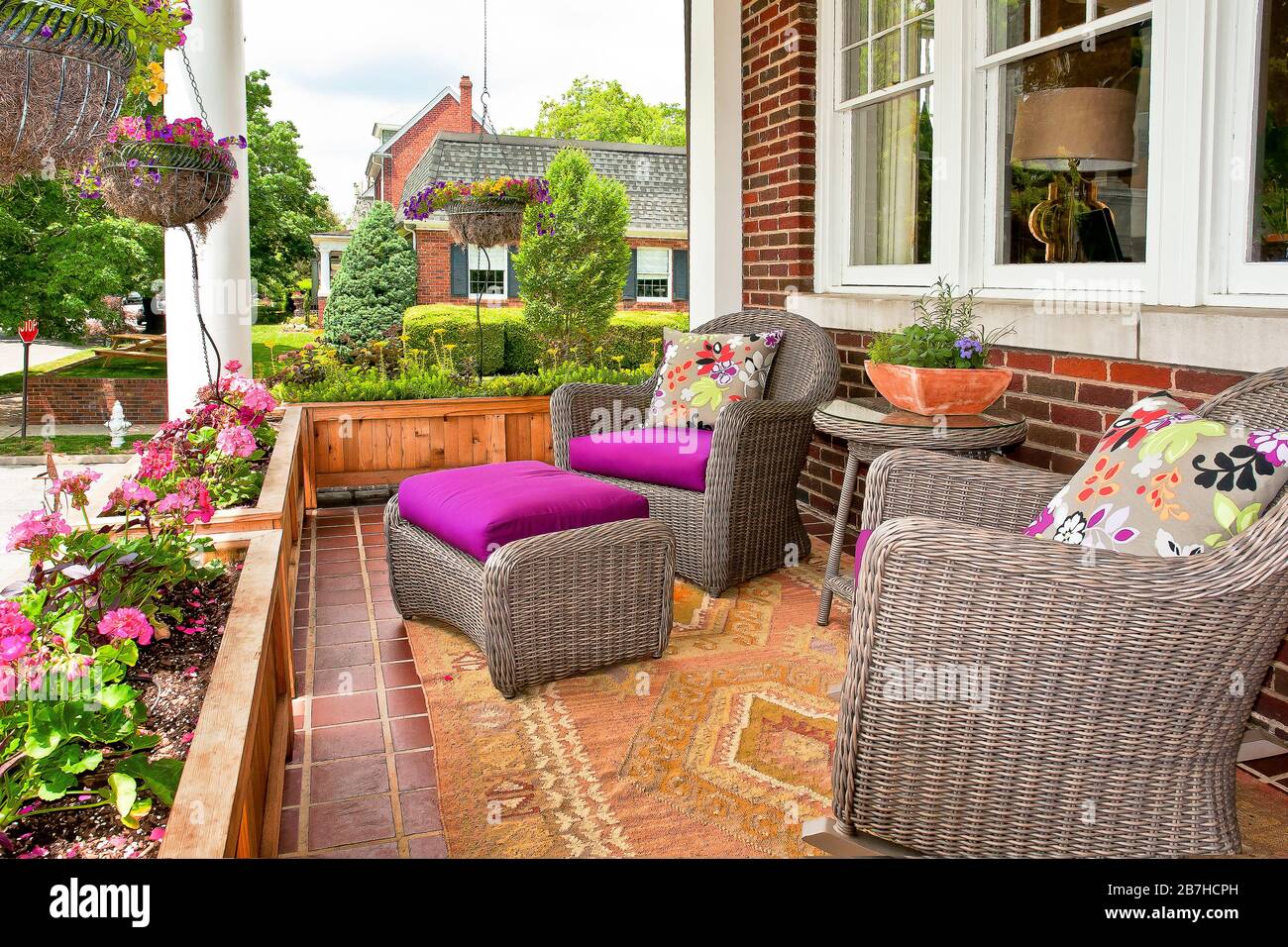 Furnished Front Porch with flower garden Stock Photo - Alamy