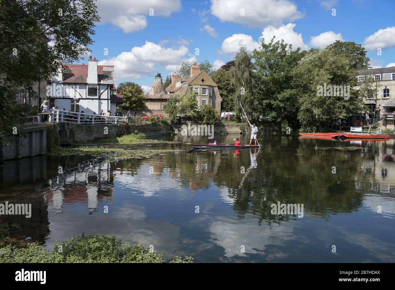 Cambridge, Cambridgeshire, United Kingdom - Tourists on punt trip (sightseeing with boat) along River Cam in the city of Cambridge, Unite Stock Photo