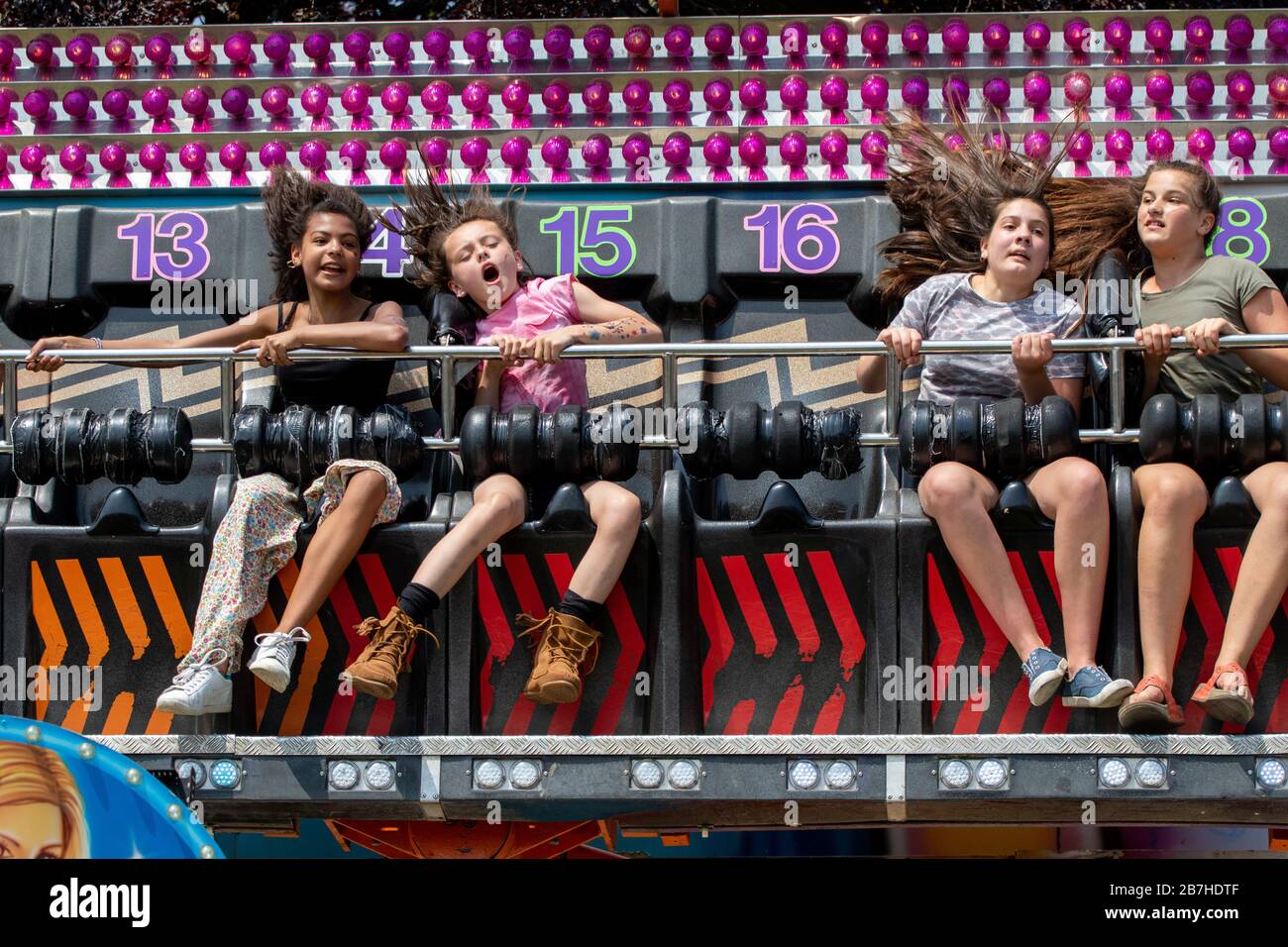 The flying hair of teenage girls on a fun fair ride Stock Photo