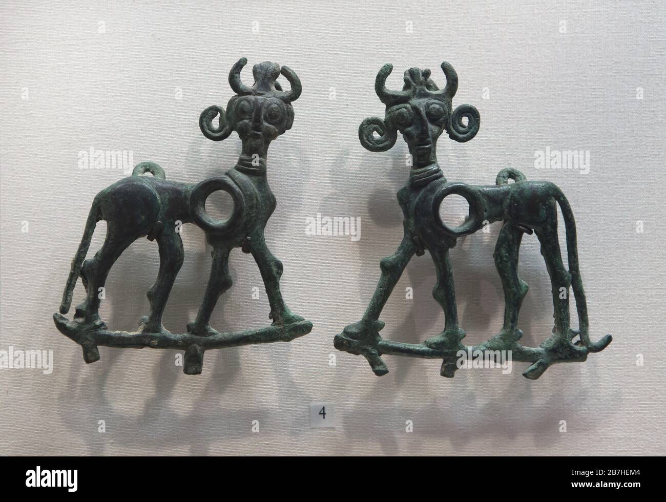 Luristan bronze plates in the shape of the winged bulls (lamassu) dated from the 8th or 7th century BC on display in the Louvre Museum in Paris, France. Stock Photo