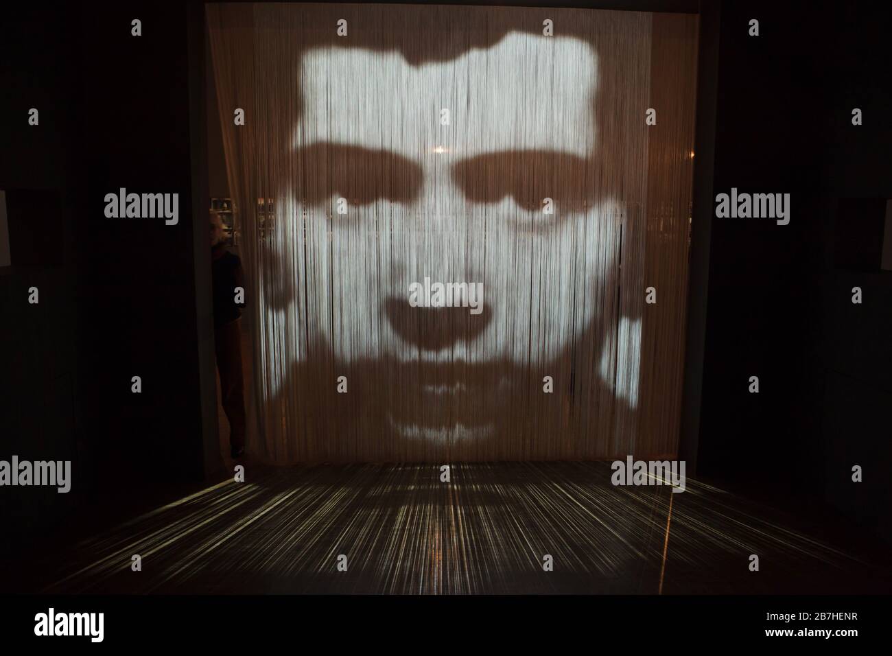 https://c8.alamy.com/comp/2B7HENR/visitor-passes-though-the-installation-by-french-conceptual-artist-christian-boltanski-entitled-between-times-2003-displayed-at-his-retrospective-exhibition-in-the-centre-pompidou-in-paris-france-the-installation-performs-black-and-white-video-projection-on-the-string-curtain-the-exhibition-punctuating-the-career-of-french-conceptual-artist-runs-till-16-march-2020-2B7HENR.jpg