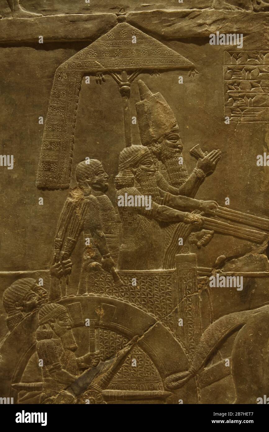 King Ashurbanipal during the campaign against Elam depicted in the Assyrian relief from the King Ashurbanipal Palace in Nineveh dated from 645 BC on display in the Louvre Museum in Paris, France. Stock Photo