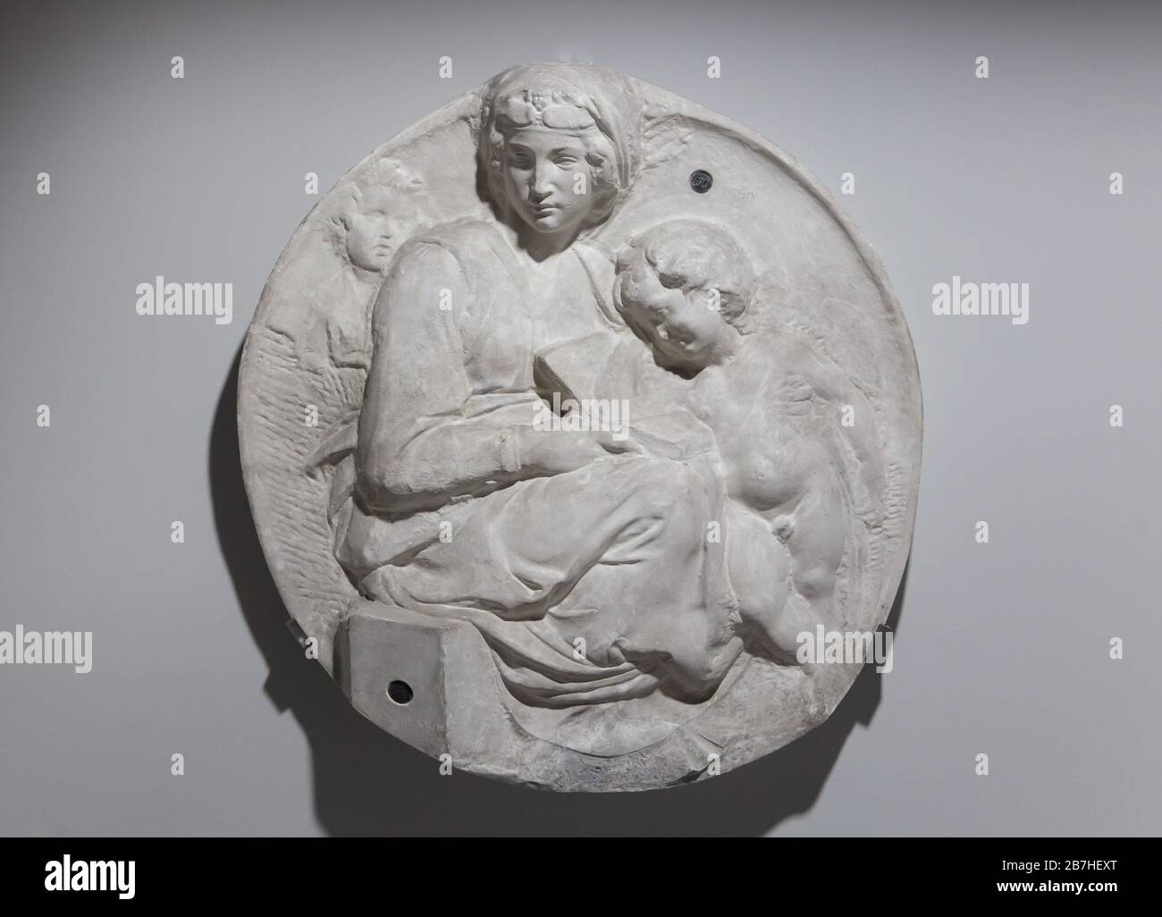 Plaster cast of the marble relief of Madonna and Child with Young Saint John the Baptist, known as the Pitti Tondo by Italian Renaissance sculptor Michelangelo Buonarroti (1505). Plaster cast dated from the end of the 19th century. Stock Photo