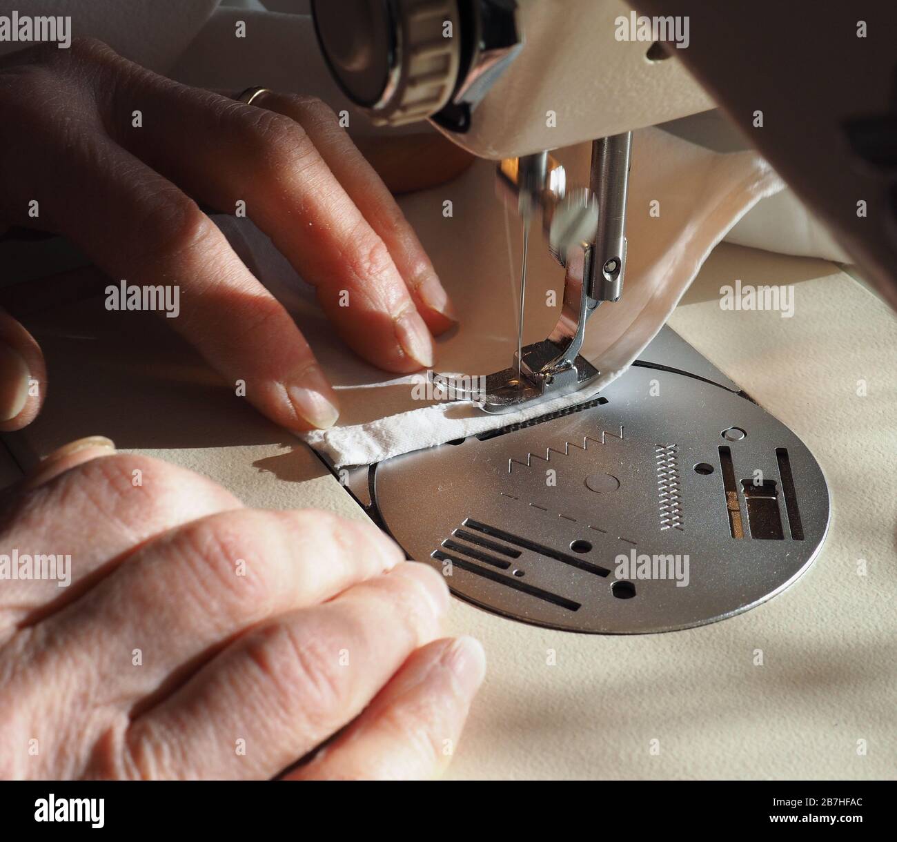 sewing machine to sew pieces of cloth together, motion blur showing needle movement Stock Photo