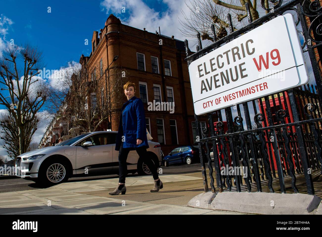 Babs Watson passes a Jaguar i-Pace on Sutherland Avenue, London, which has been coined as Electric Avenue, W9, to mark that all lampposts on the street have been fully converted to SIEMENS and ubitricity Electric Vehicle charging points. Stock Photo