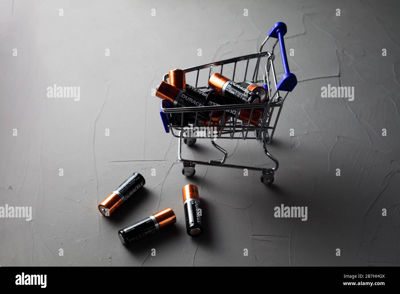 supermarket trolley and durasel batteries on concrete background Stock