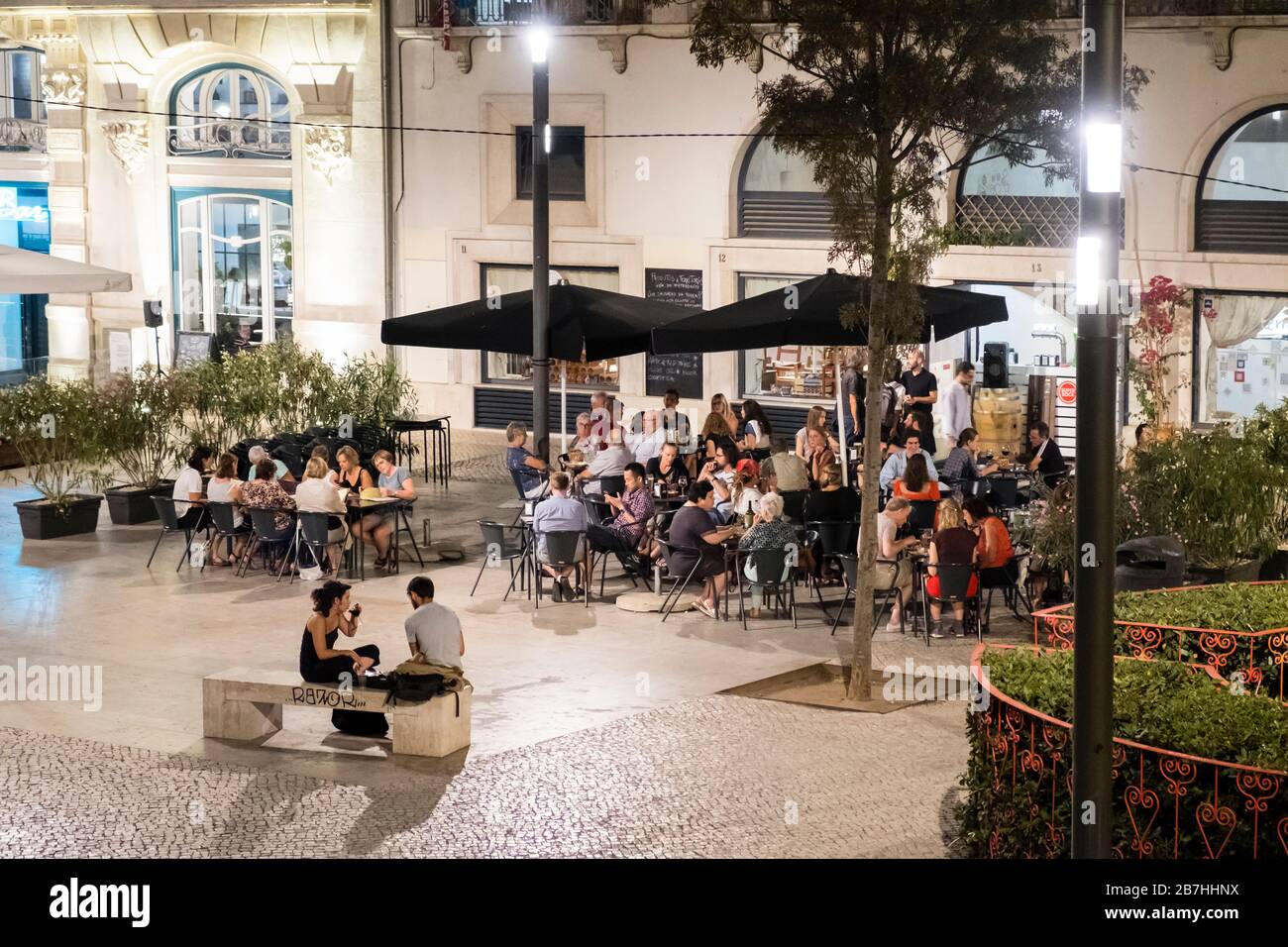 Patrons at an outdoor restaurant & bar, Lisbon, Portugal Stock Photo