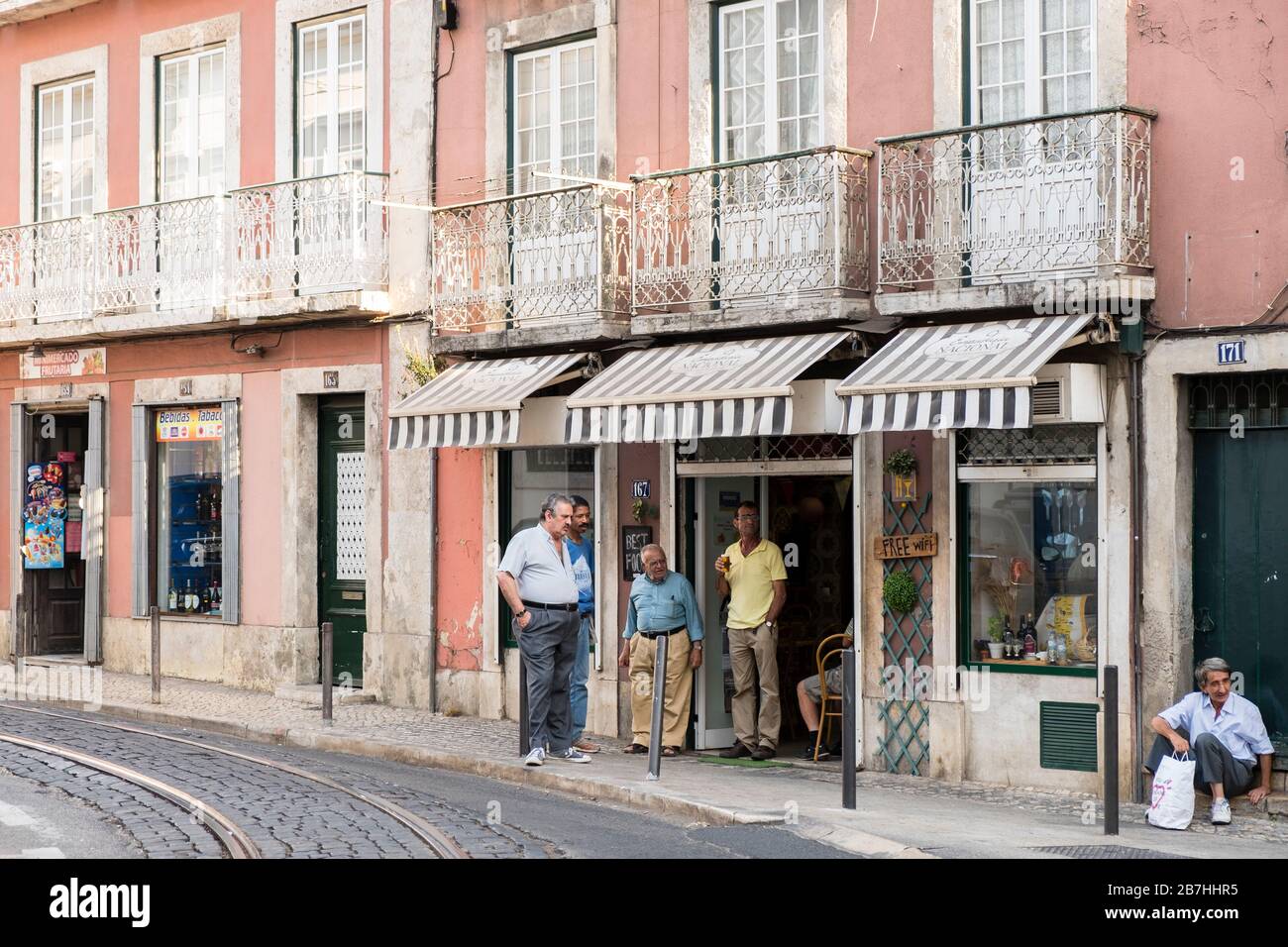 Several Portuguese men on a sidewalk in Lisbon Stock Photo