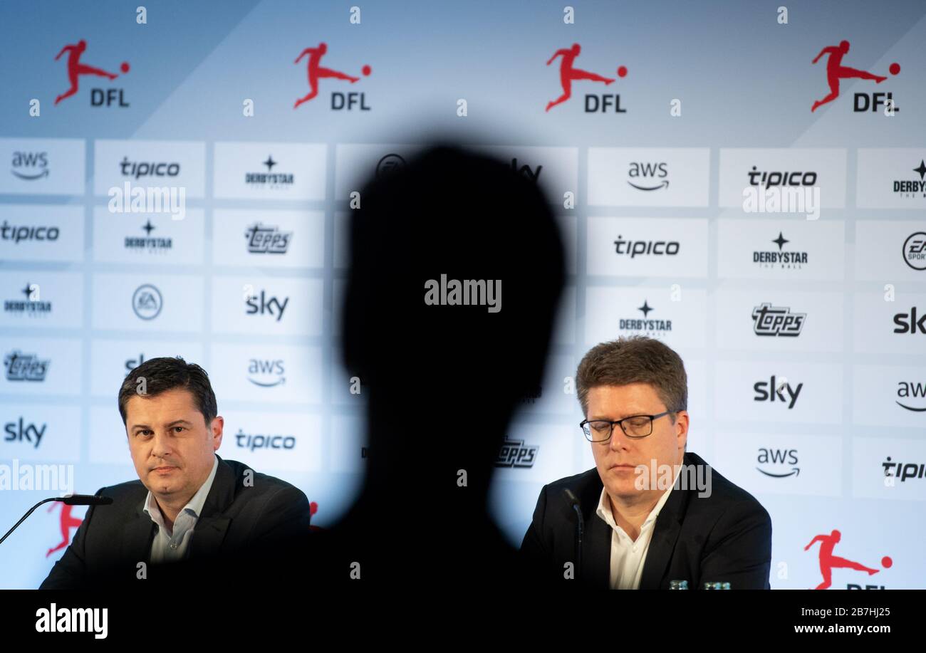 Frankfurt, Germany. 16 March 2020. At a press conference following the general meeting of the German Football League (DFL), a journalist asks Christian Seifert (l), managing director of DFL GmbH and spokesman for the executive board of DFL e.V., who sits next to Christian Pfenning, DFL Director of Corporate and Brand Communications. In view of the coronavirus crisis, the 36 professional clubs decided to suspend the Bundesliga and 2nd division until at least 2 April. Credit: dpa picture alliance/Alamy Live News Stock Photo